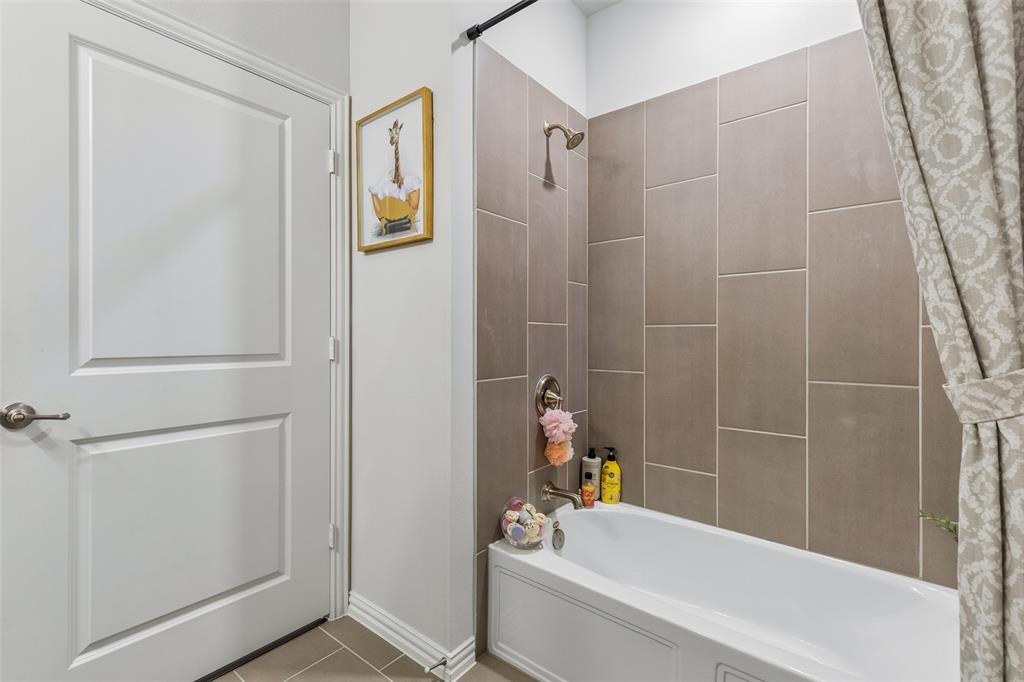 651 Watters Road, Unit 7204 Allen, TX 75013 - Photo 29 of 40 a bathroom with a bathtub and a shower