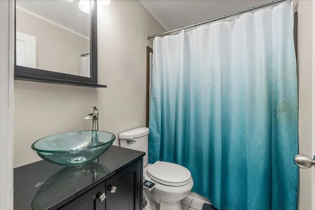 a bathroom with a sink a toilet and a mirror