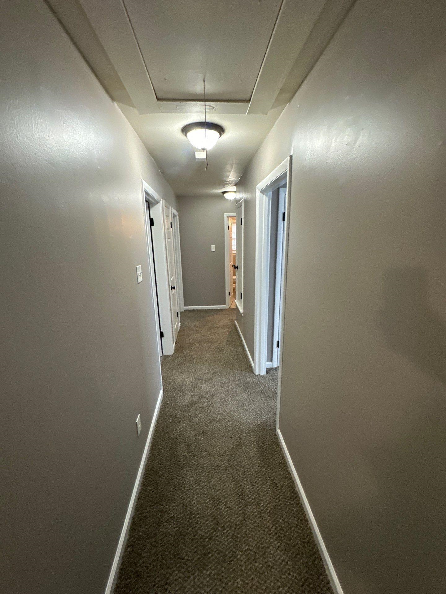10 West Mitchell Road Memphis, TN 38109 - Photo 8 of 11 Hallway with attic access, baseboards, and dark carpet
