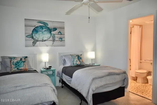 a bedroom with a bed and a painting on the wall