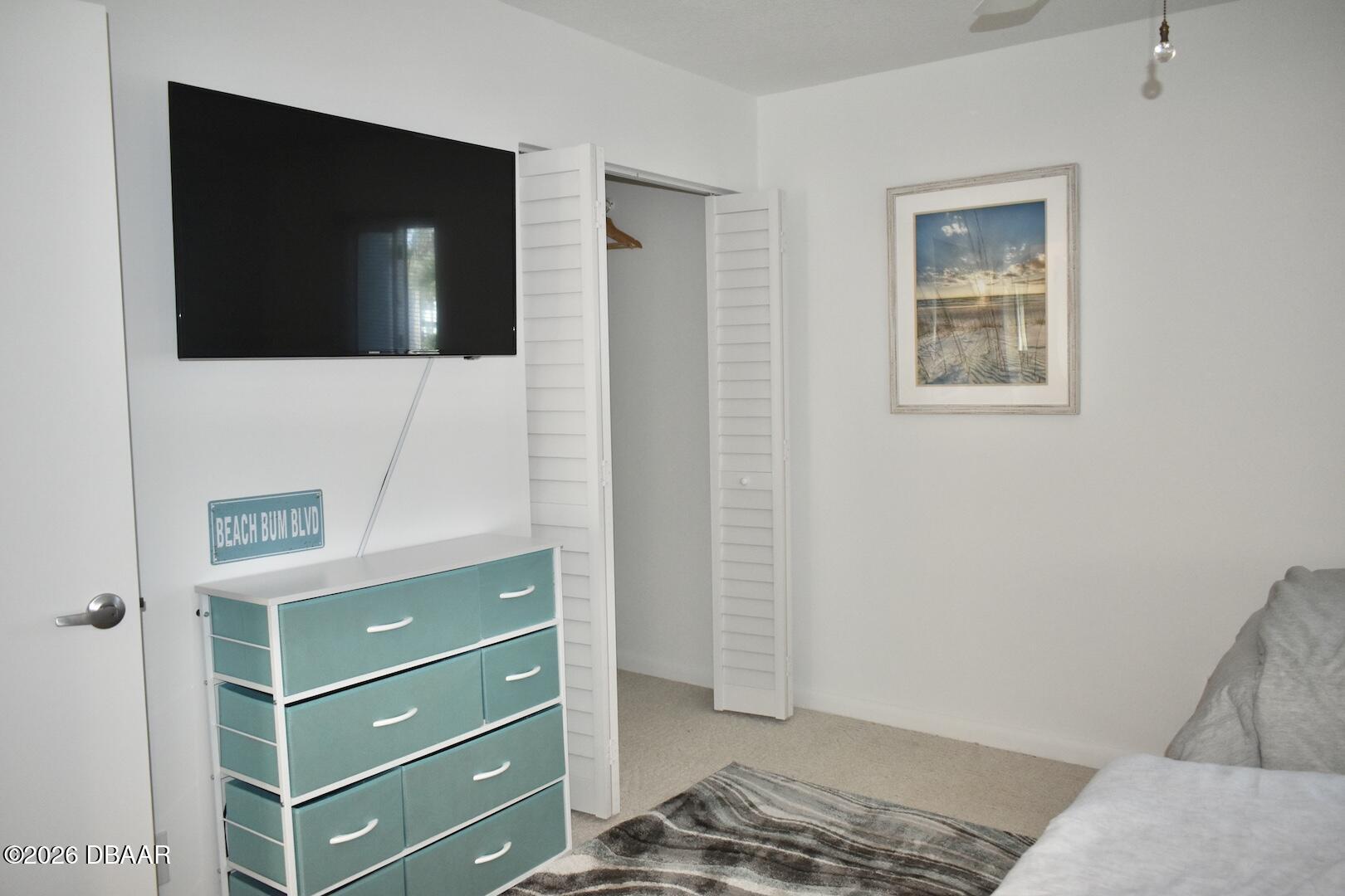 4790 South Atlantic Avenue, Unit F602 Ponce Inlet, FL 32127 - Photo 15 of 23 a bedroom with a bed and a cabinet