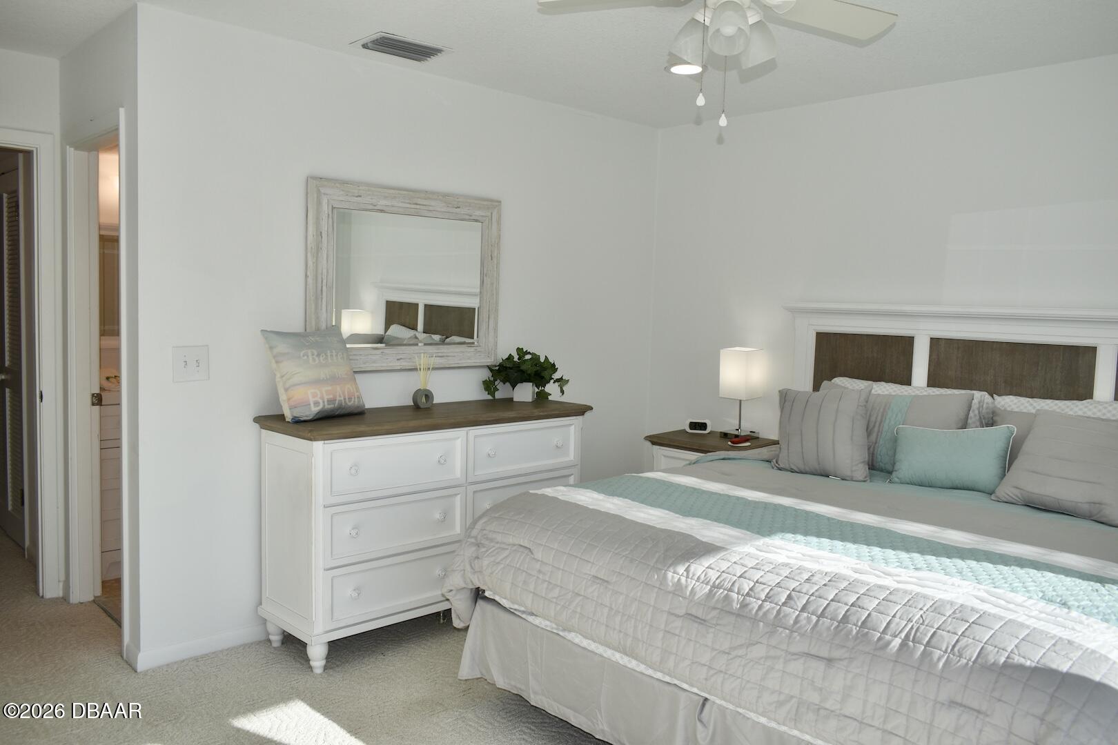 4790 South Atlantic Avenue, Unit F602 Ponce Inlet, FL 32127 - Photo 17 of 23 a bedroom with a large bed and a chandelier