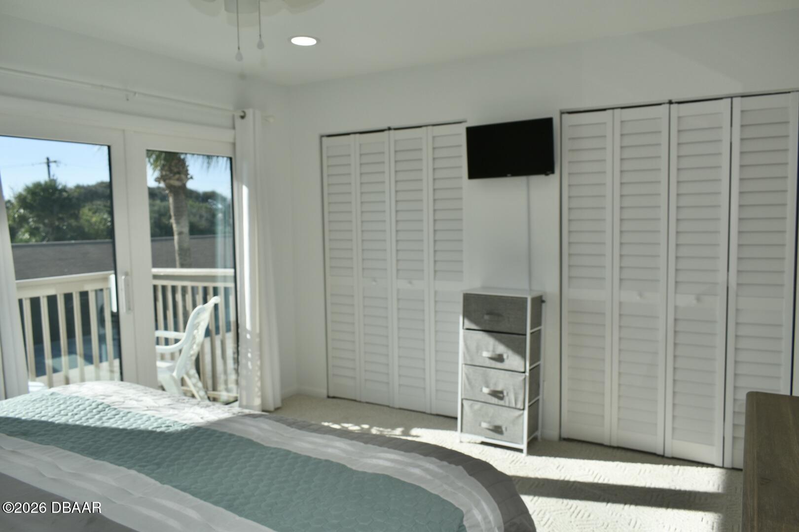 4790 South Atlantic Avenue, Unit F602 Ponce Inlet, FL 32127 - Photo 18 of 23 a view of a bedroom with a flat tv screen and a sink