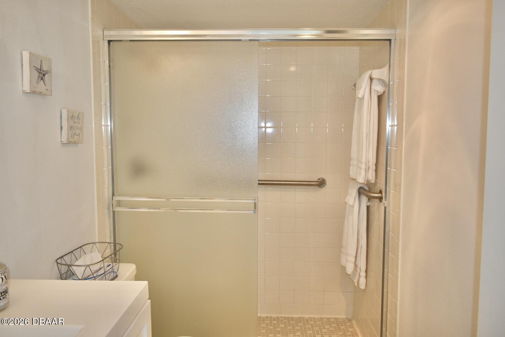 4790 South Atlantic Avenue, Unit F602 Ponce Inlet, FL 32127 - Photo 21 of 23 a bathroom with a glass shower door
