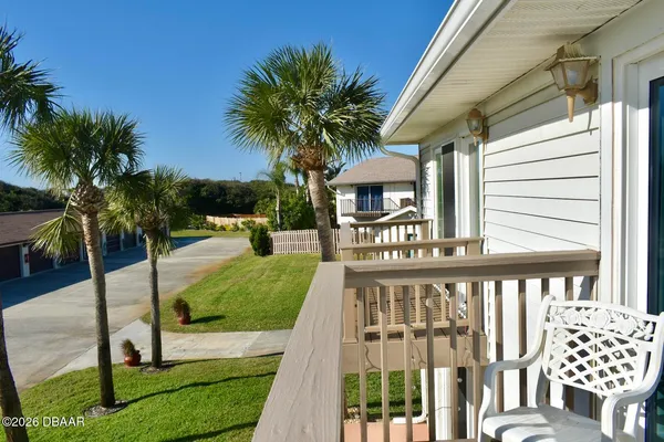 a view of a house with backyard and porch