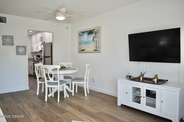 a view of a dining room with furniture and wooden floor