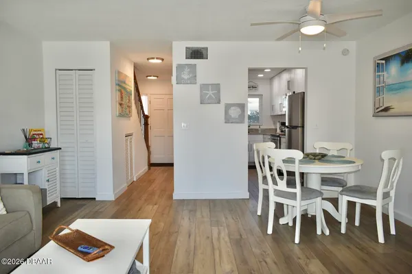 a view of a dining room with furniture and wooden floor