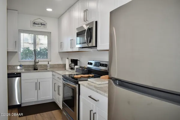 a kitchen with a sink stove and microwave