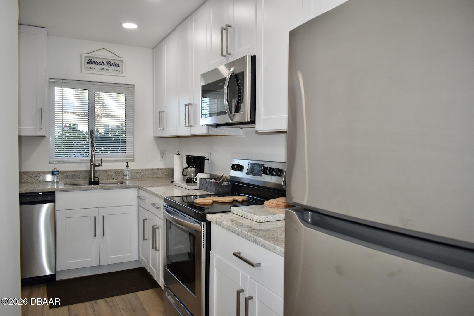 4790 South Atlantic Avenue, Unit F602 Ponce Inlet, FL 32127 - Photo 7 of 23 a kitchen with a sink stove and microwave
