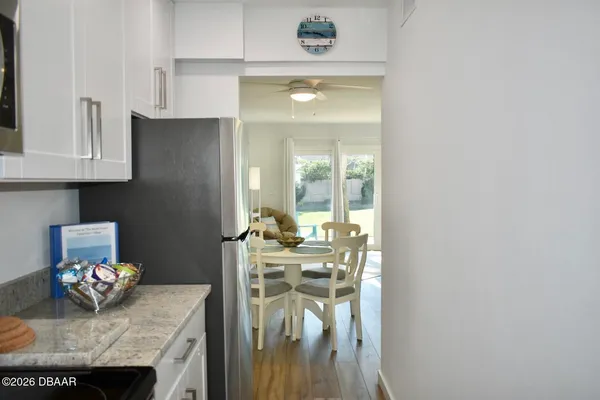 a view of living room with granite countertop furniture a fireplace and a flat screen tv
