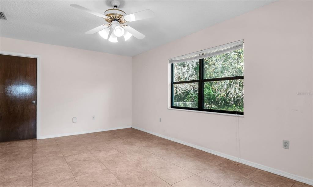 10960 Echo Loop New Port Richey, FL 34654 - Photo 22 of 38 an empty room with a window and a ceiling fan