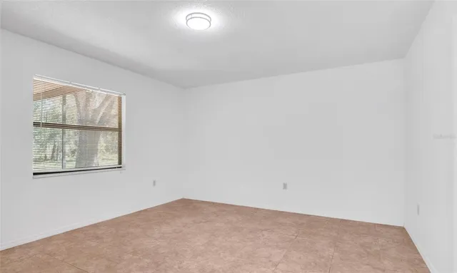 an aerial view of a houses with a lush green hillside