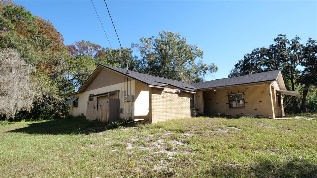 10960 Echo Loop New Port Richey, FL 34654 - Photo 33 of 38 a front view of house with yard and trees in the background