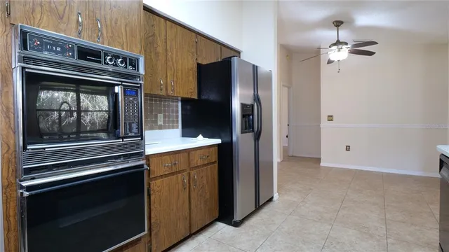 a kitchen with stainless steel appliances granite countertop a refrigerator and a stove