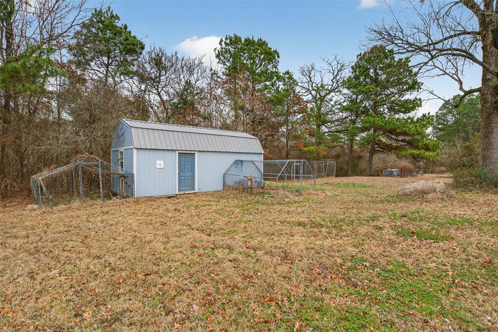 720 Haggerty Road Karnack, TX 75661 - Photo 29 of 39 a house with trees in front of it