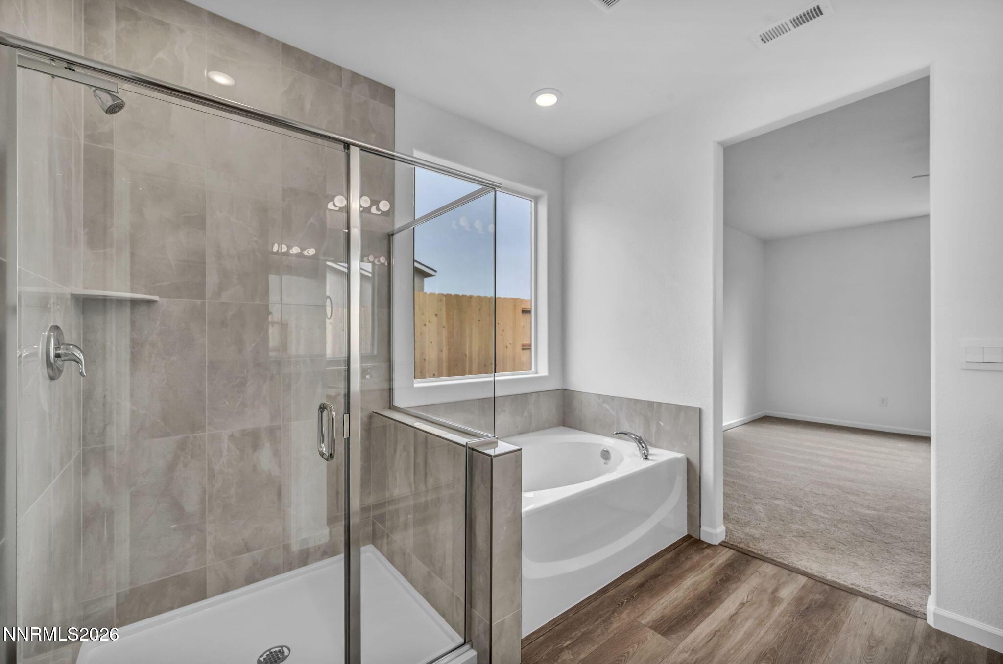6663 Morgan Mill Road, Unit HOMESITE 44 Carson City, NV 89701 - Photo 17 of 26 a white bath tub sitting next to a shower