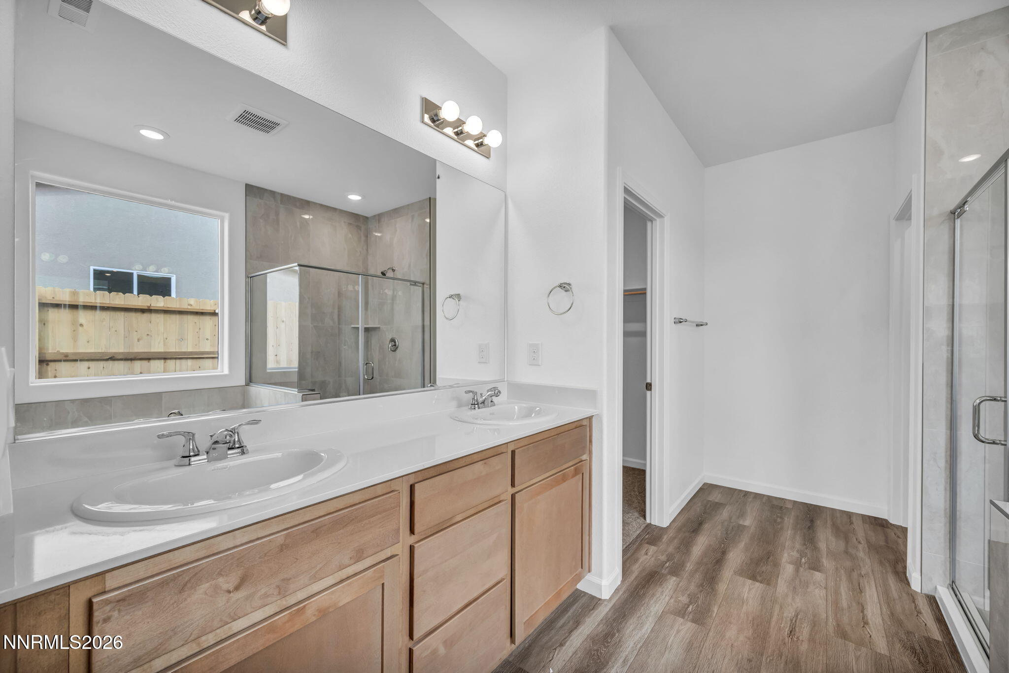 6663 Morgan Mill Road, Unit HOMESITE 44 Carson City, NV 89701 - Photo 18 of 26 a bathroom with a sink double vanity granite tub and shower