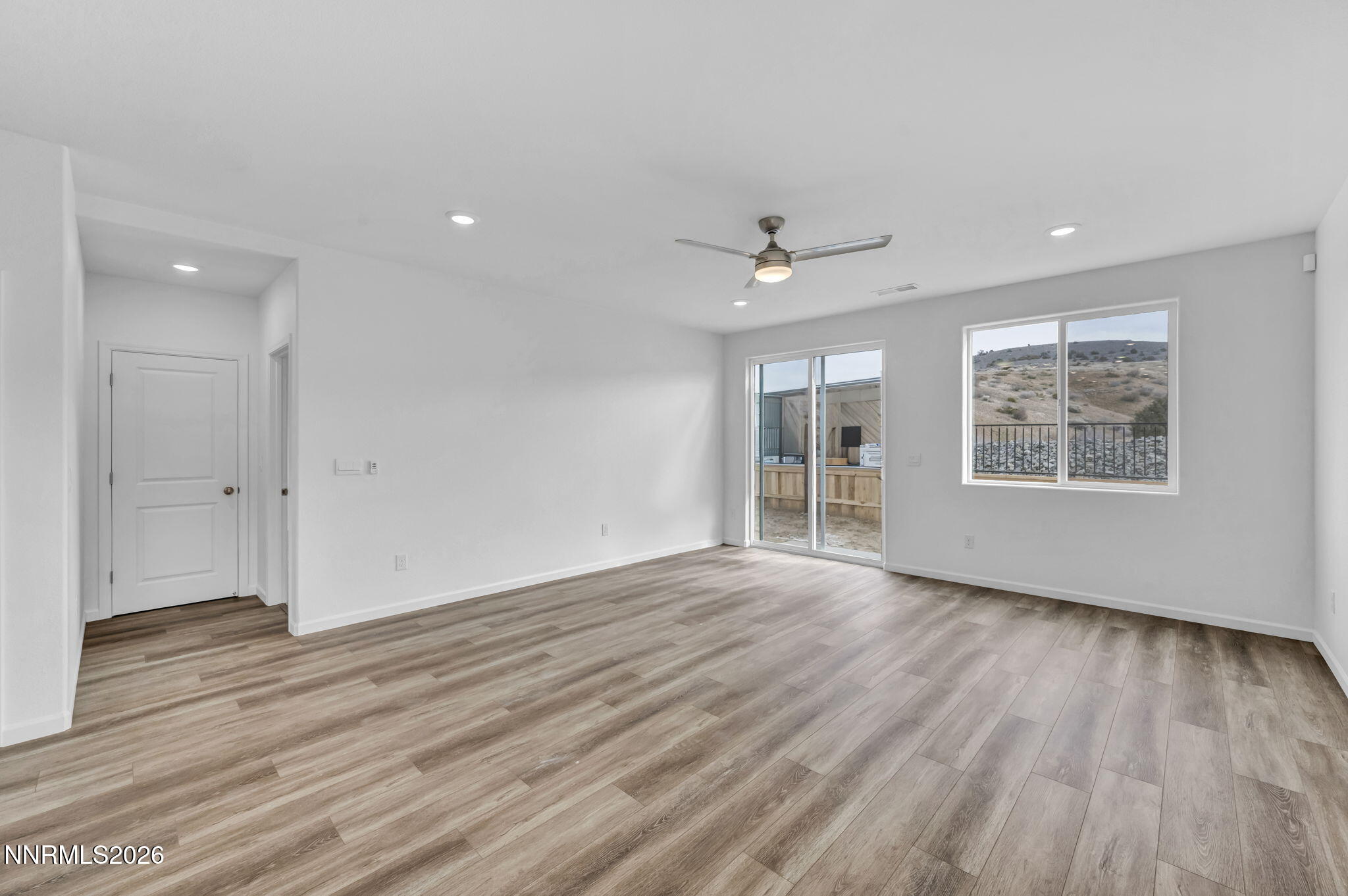 6663 Morgan Mill Road, Unit HOMESITE 44 Carson City, NV 89701 - Photo 8 of 26 an empty room with wooden floor and windows