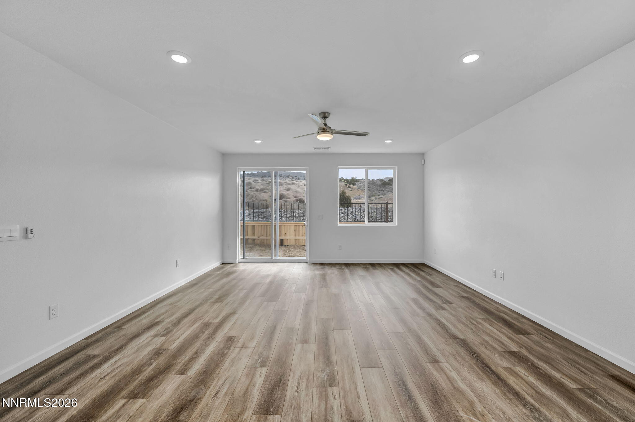 6663 Morgan Mill Road, Unit HOMESITE 44 Carson City, NV 89701 - Photo 9 of 26 wooden floor in an empty room with a window