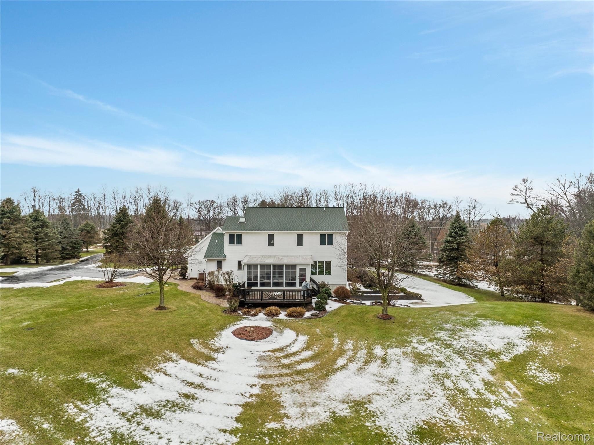 2755 County Farm Road Howell, MI 48843 - Photo 38 of 39 Rear view with deck and enclosed sun porch.