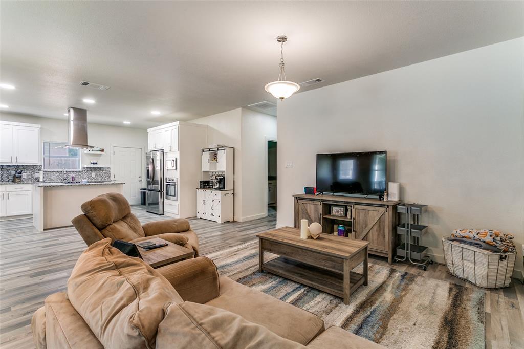 1108 South Morris Street Gainesville, TX 76240 - Photo 6 of 23 a living room with furniture and a flat screen tv