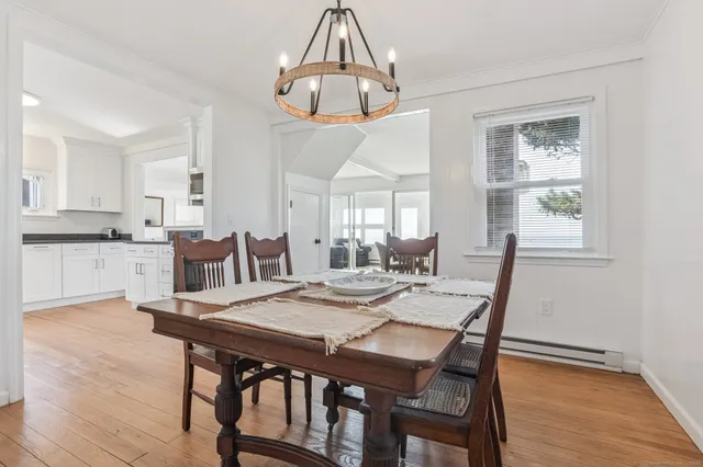a view of a dining room with furniture wooden floor and chandelier