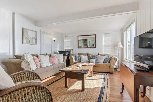 a living room with furniture a flat screen tv and a couch