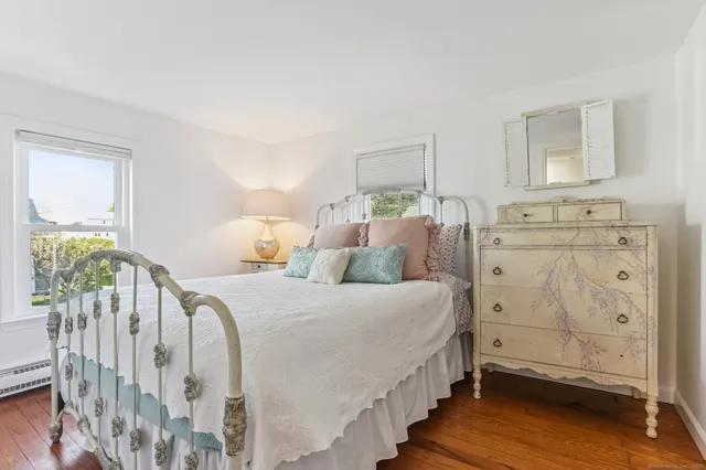 a spacious bedroom with a bed and a baby crib