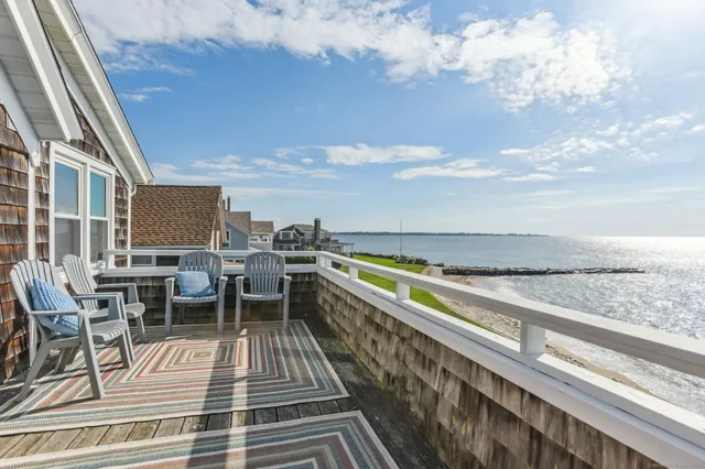 a front view of a house with a garden and trees