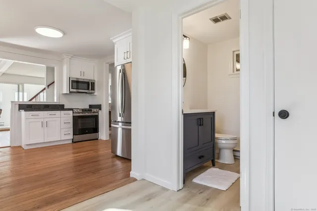 a kitchen with stainless steel appliances granite countertop a refrigerator and a stove