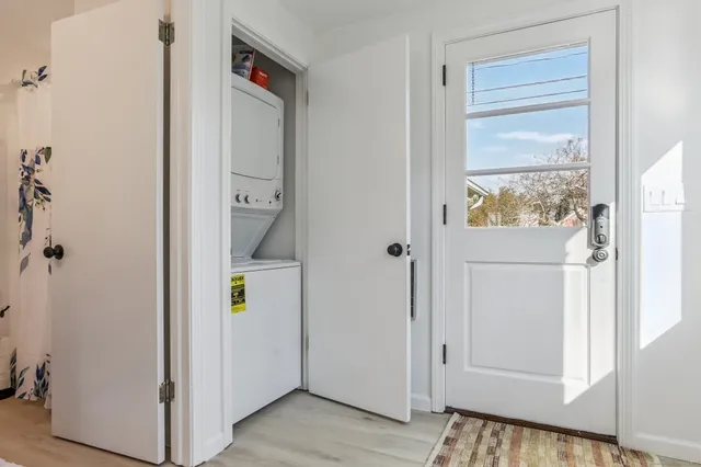 a view of an entryway with wooden floor