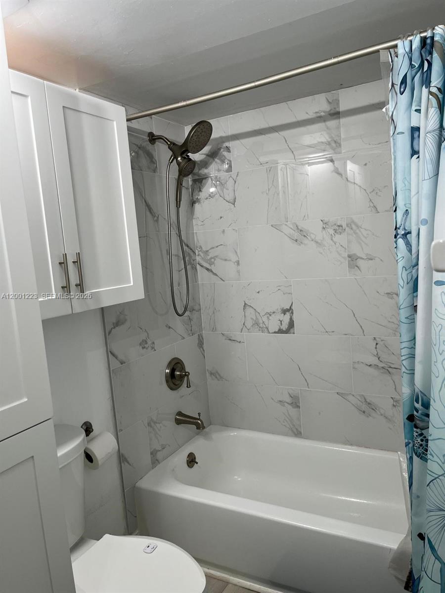 280 Southwest 20th Road, Unit 504 Miami, FL 33129 - Photo 17 of 23 a bathroom with a shower and a toilet