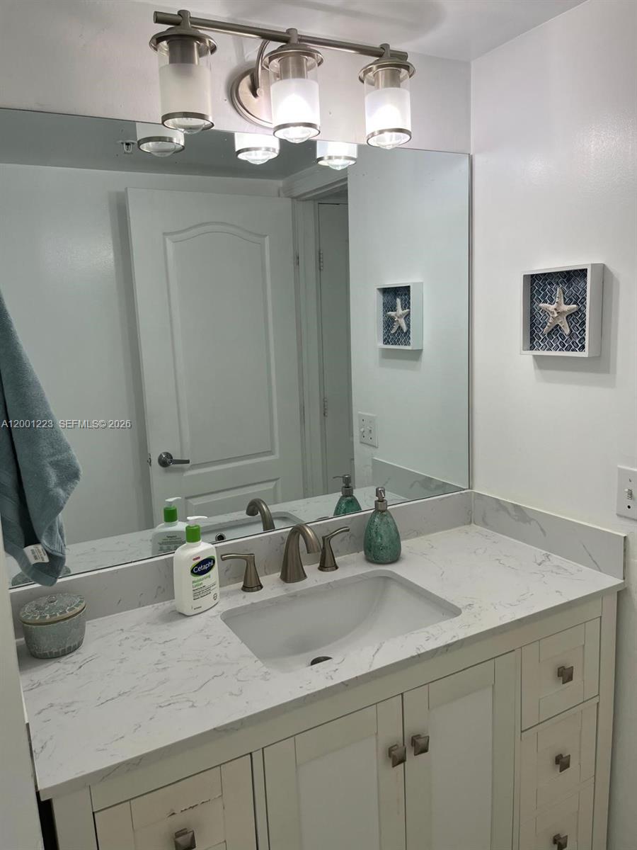 280 Southwest 20th Road, Unit 504 Miami, FL 33129 - Photo 19 of 23 a bathroom with a sink and a mirror