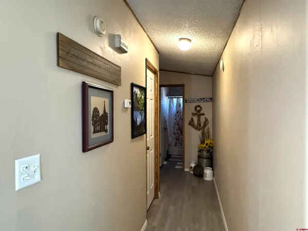 a view of a hallway with paintings on the wall