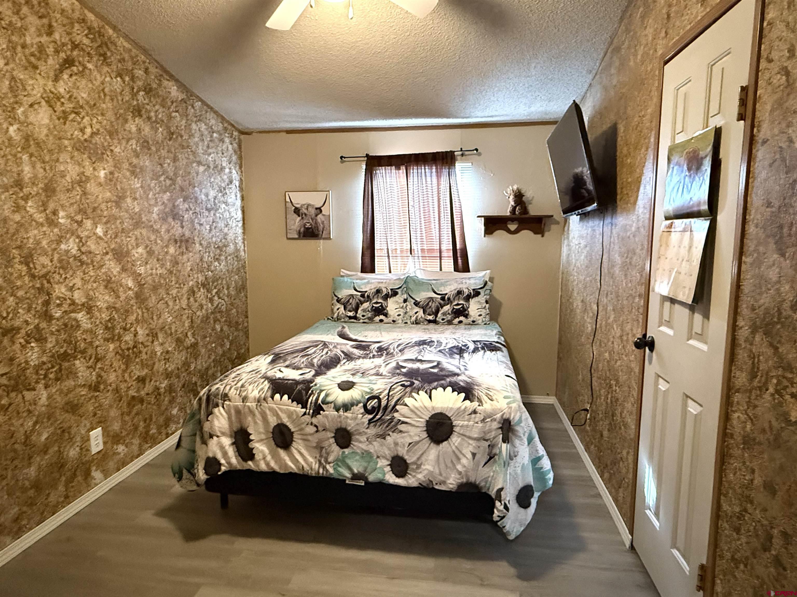 15546 Rd BB Pleasant View, CO 81331 - Photo 15 of 29 a bedroom with a bed and a window