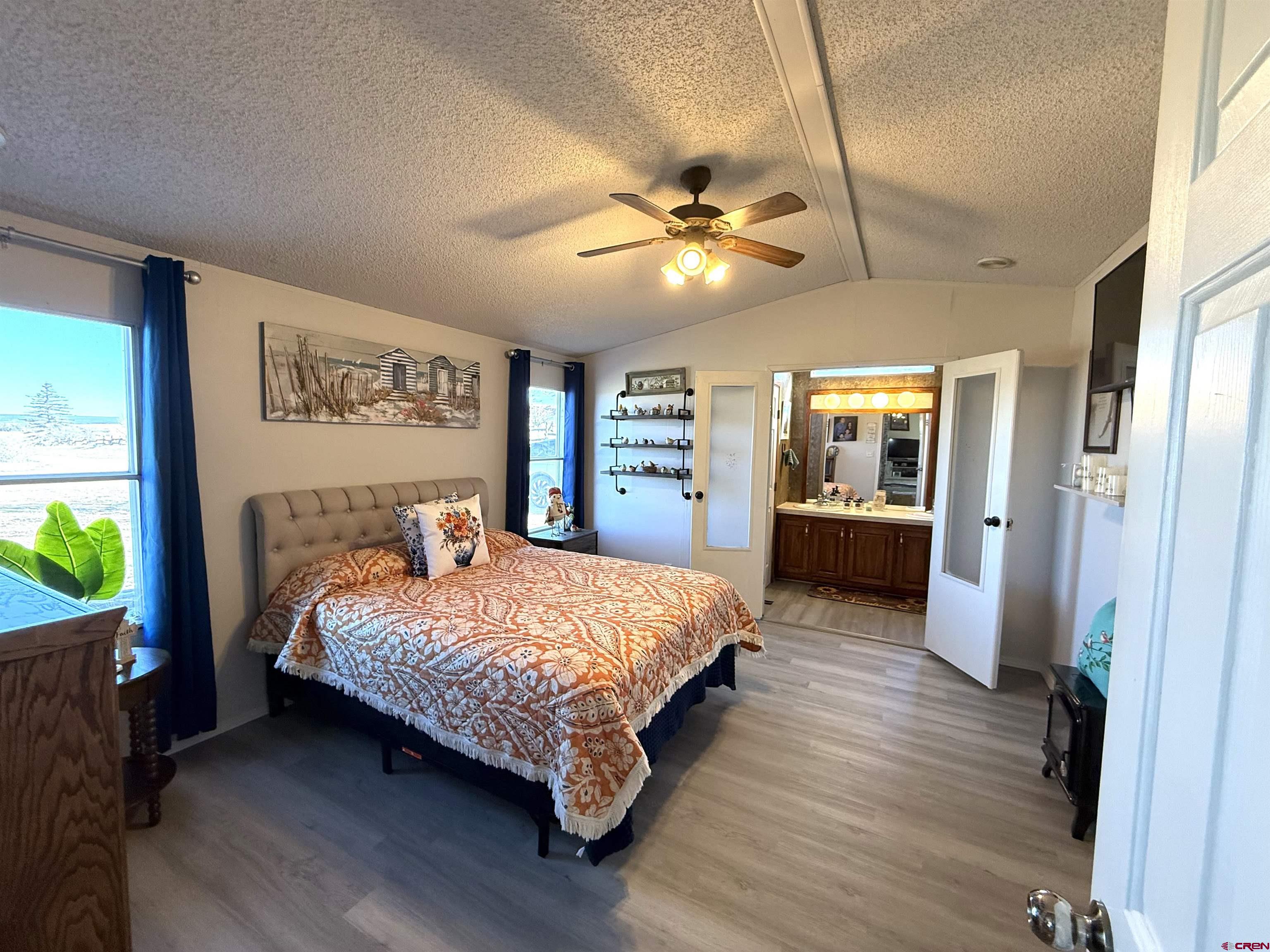 15546 Rd BB Pleasant View, CO 81331 - Photo 16 of 29 a bedroom with a beds chandelier and a window