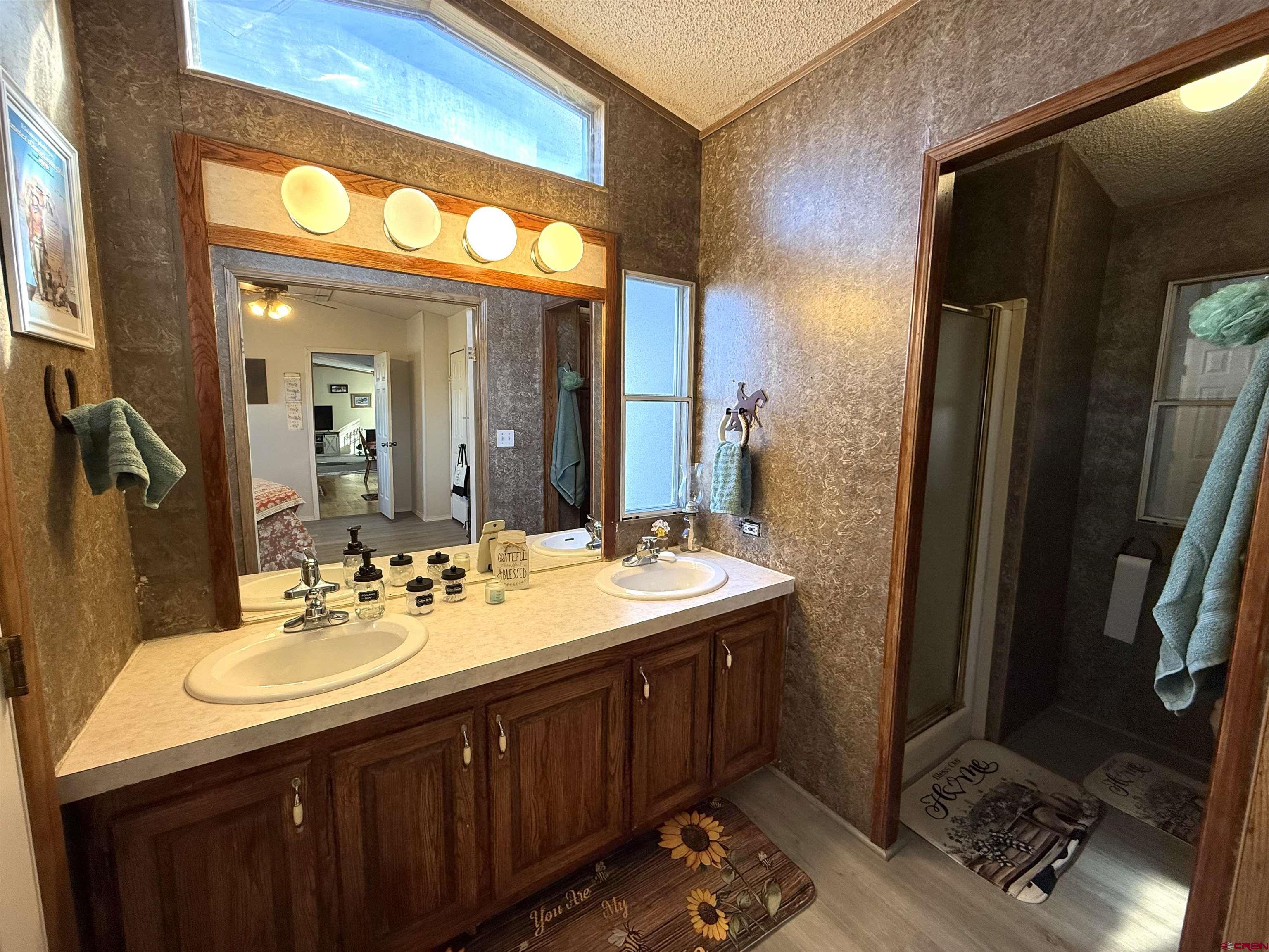 15546 Rd BB Pleasant View, CO 81331 - Photo 17 of 29 a bathroom with a sink double vanity and a mirror