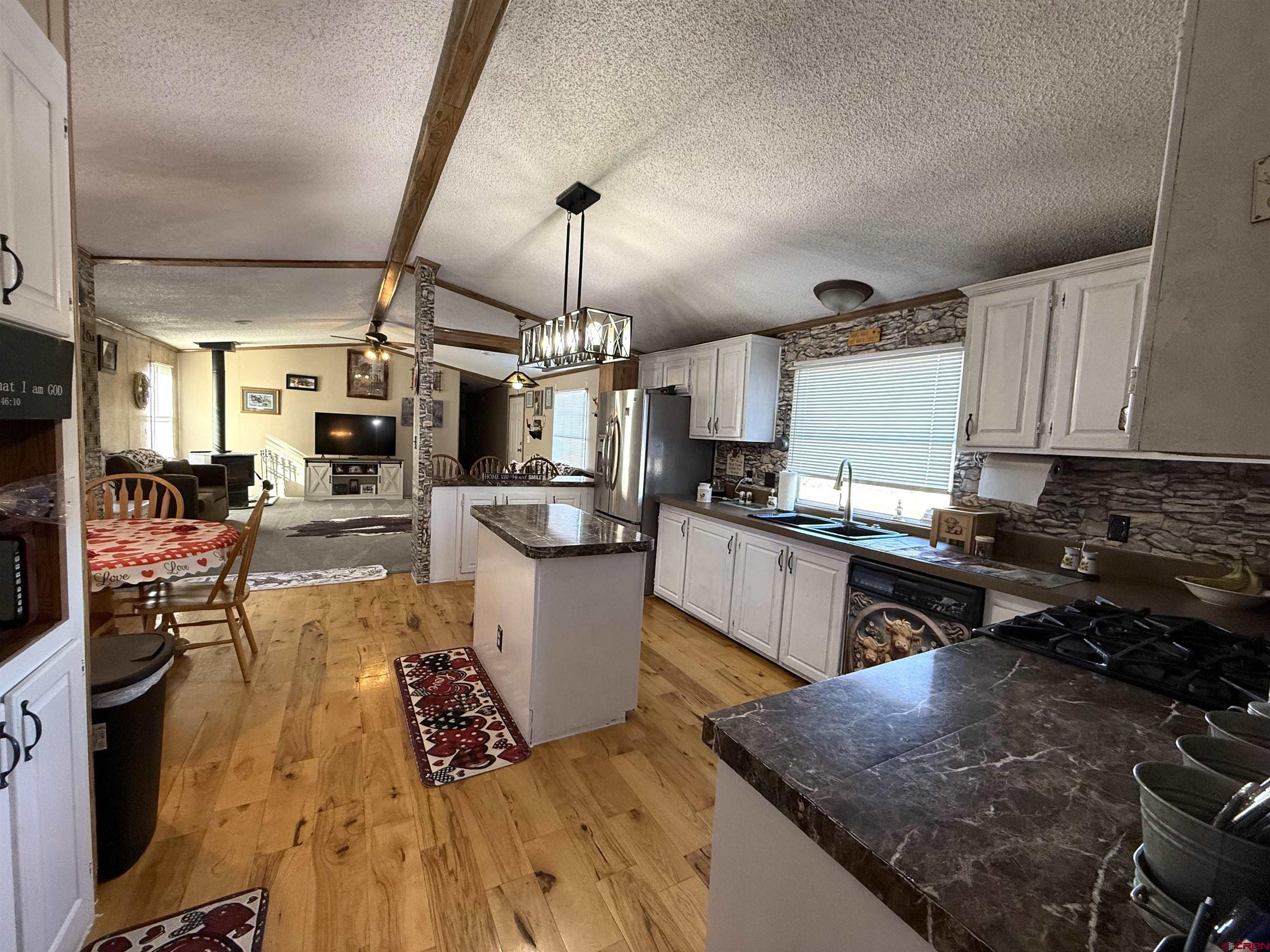 15546 Rd BB Pleasant View, CO 81331 - Photo 7 of 29 a kitchen with a sink appliances and cabinets