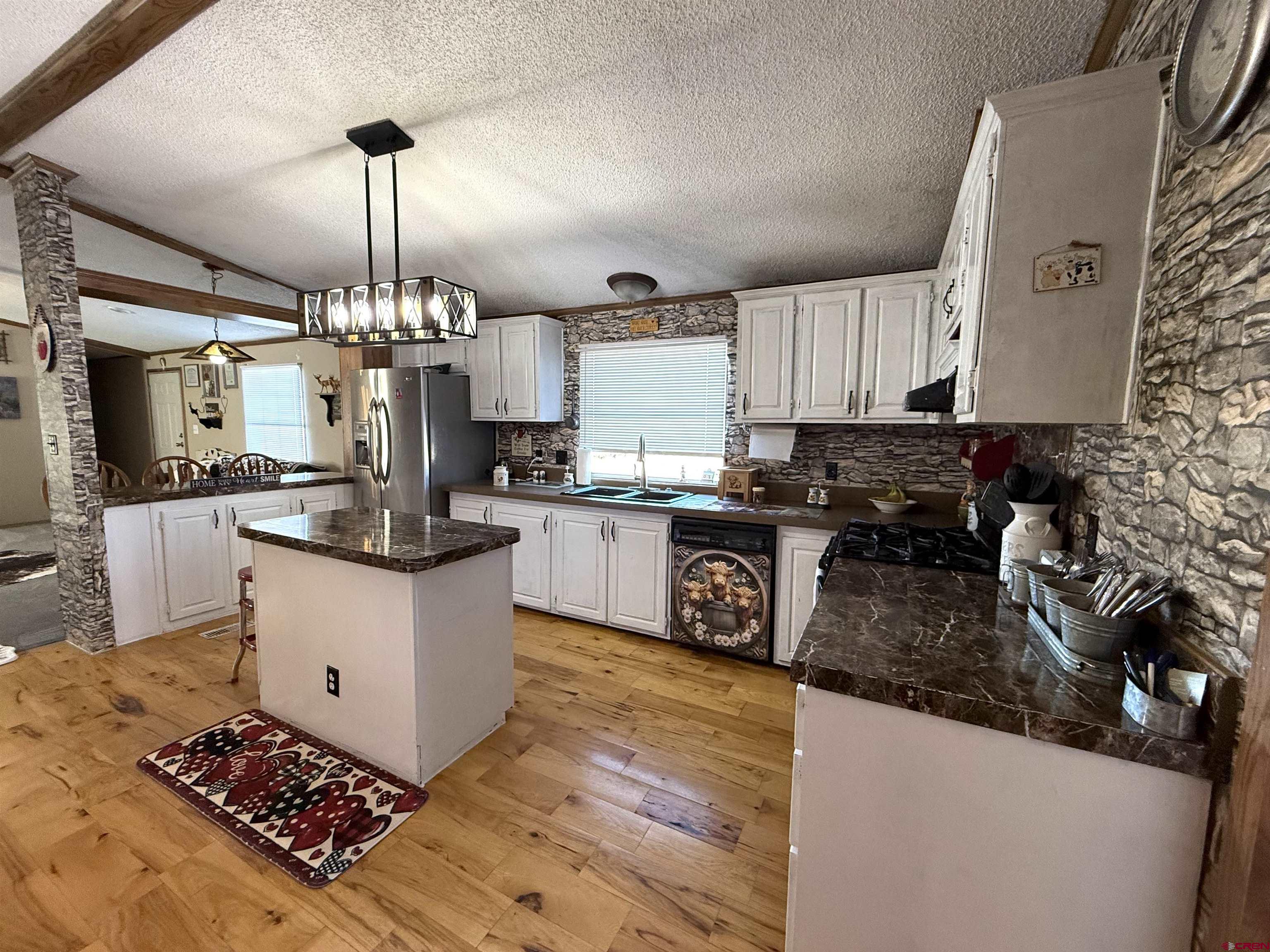 15546 Rd BB Pleasant View, CO 81331 - Photo 8 of 29 a kitchen with stainless steel appliances granite countertop a sink stove and refrigerator
