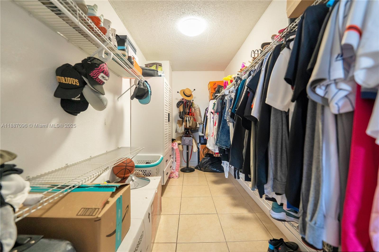 6990 Northwest 186th Street, Unit 4511 Hialeah, FL 33015 - Photo 13 of 29 a view of walk in closet with clothes and shoes