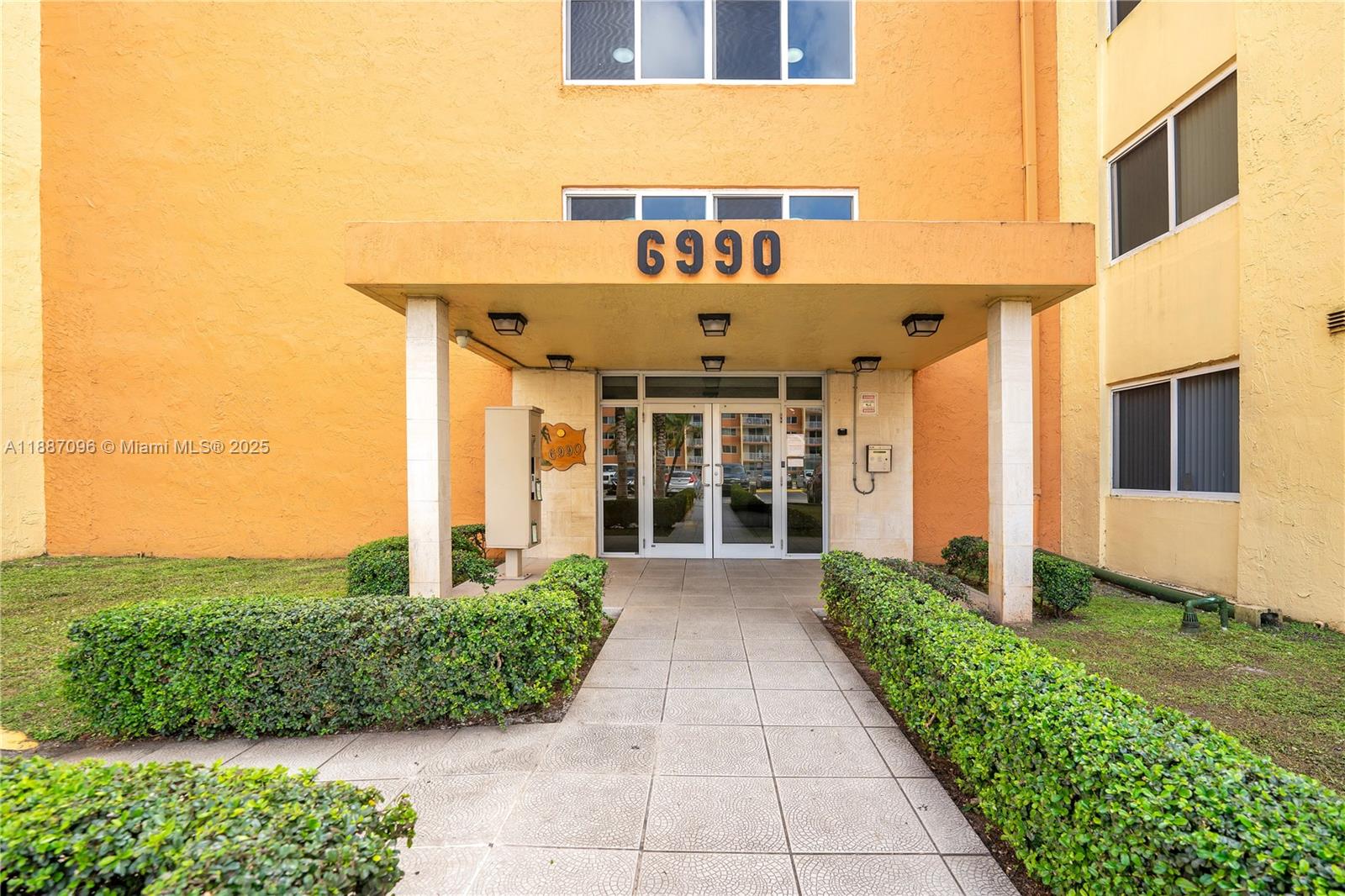 6990 Northwest 186th Street, Unit 4511 Hialeah, FL 33015 - Photo 2 of 29 a front view of a house with garden