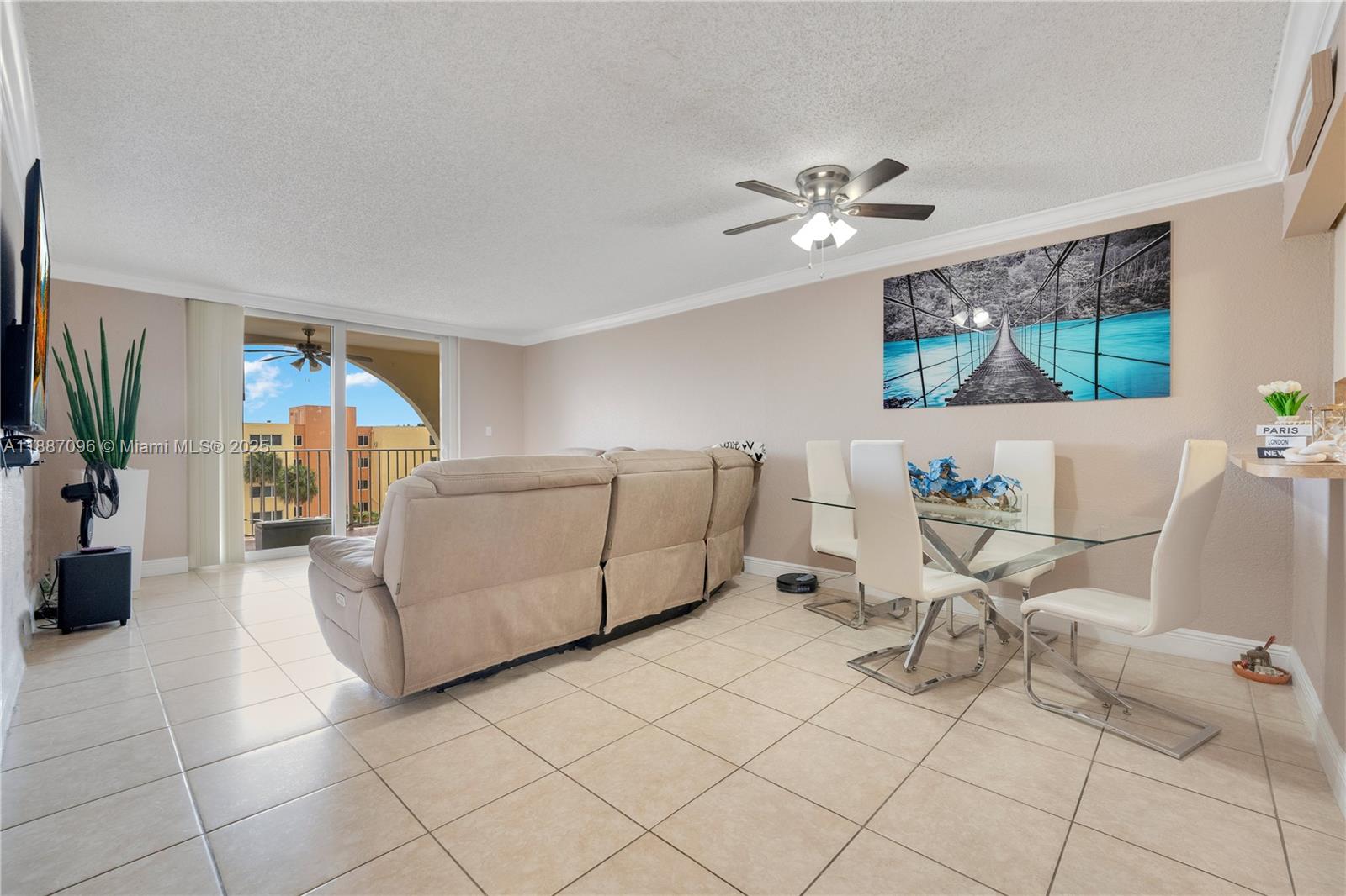 6990 Northwest 186th Street, Unit 4511 Hialeah, FL 33015 - Photo 7 of 29 a living room with furniture and a flat screen tv