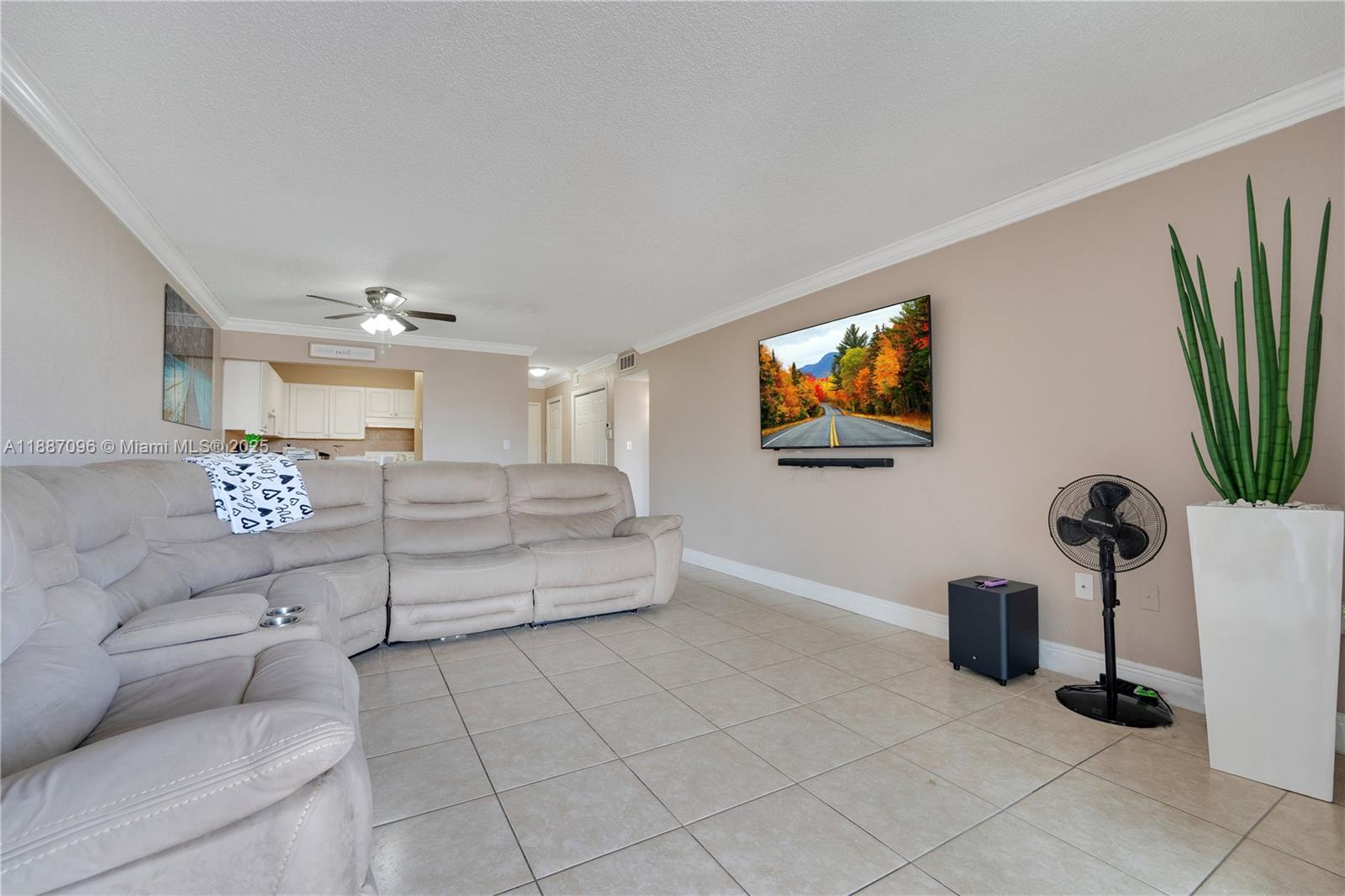 6990 Northwest 186th Street, Unit 4511 Hialeah, FL 33015 - Photo 9 of 29 a living room with furniture and a flat screen tv