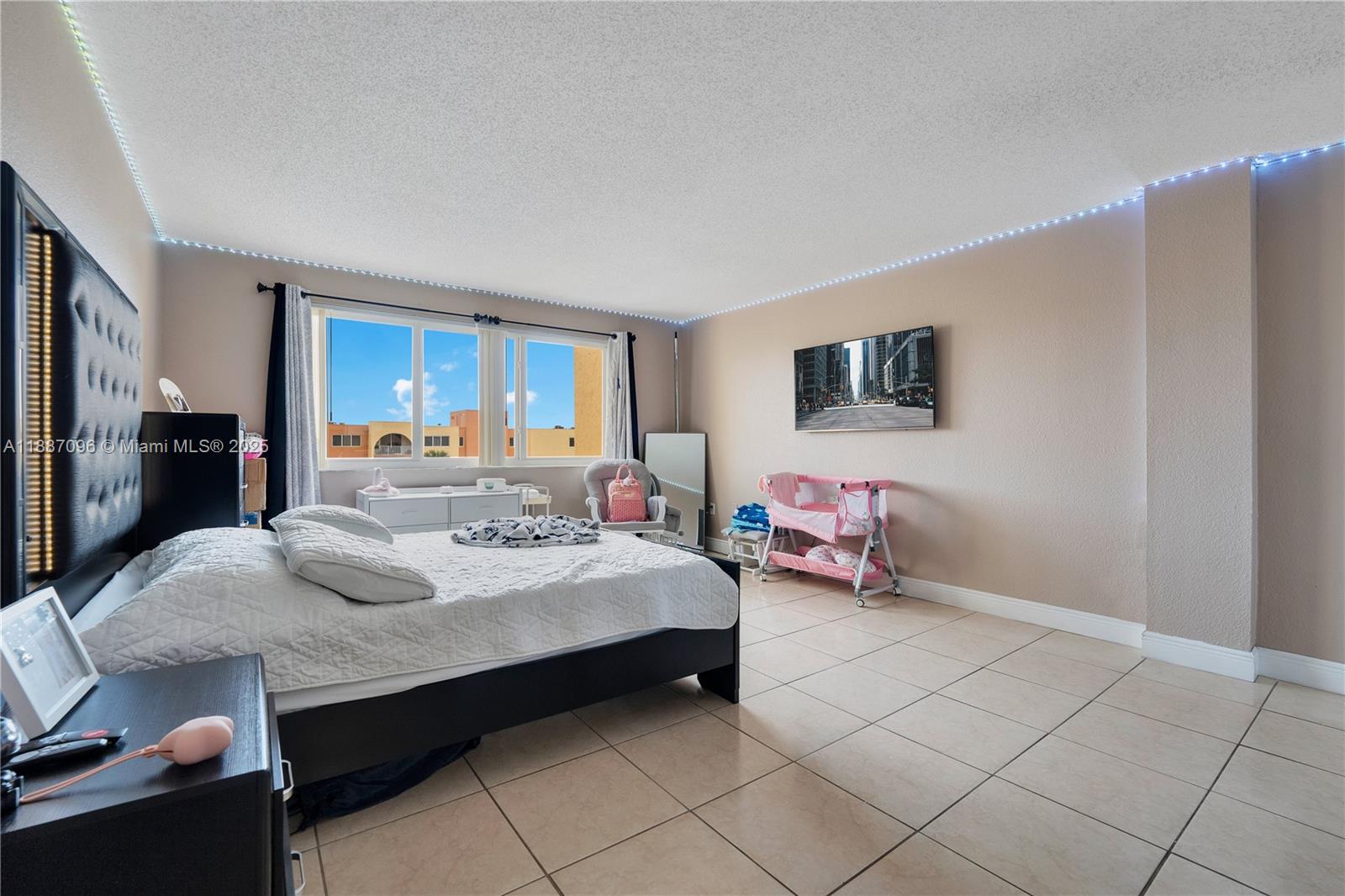 6990 Northwest 186th Street, Unit 4511 Hialeah, FL 33015 - Photo 10 of 29 a bed room with a bed and a large mirror
