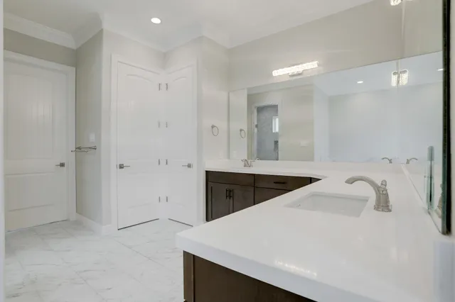 a spacious bathroom with a sink a mirror a shower and a bathtub