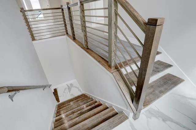 a view of staircase with white walls and a window