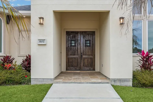 a front view of a house with a garden
