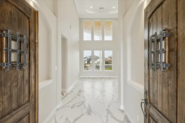 a view of an entryway with wooden floor