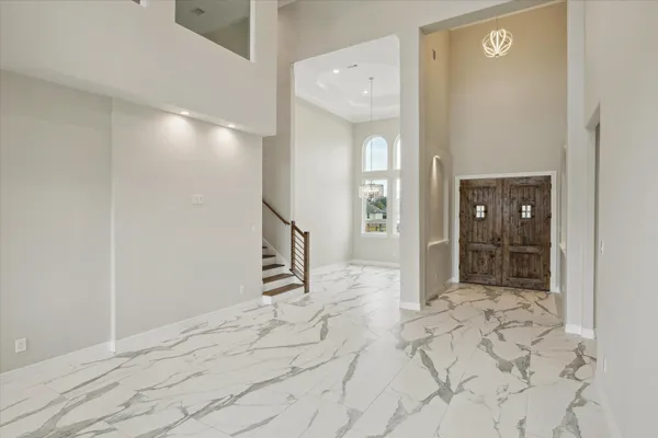 a view of a big room with wooden floor and windows