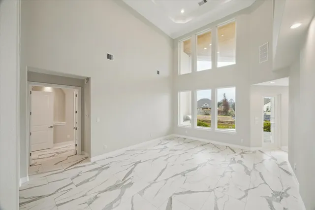 a large kitchen with stainless steel appliances kitchen island granite countertop a large stove top oven a sink dishwasher and a refrigerator with wooden floor